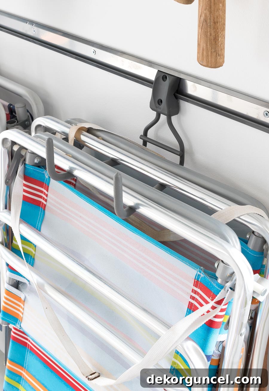 Definitely a garage must-have! These Elfa wide ladder hooks are ideal for holding folding chairs and sawhorses, in addition to ladders. I love how this garage is organized!
