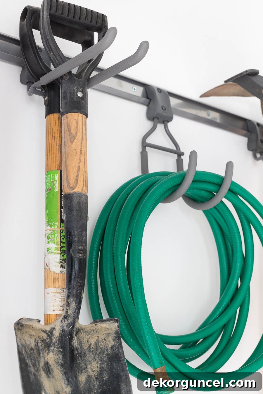 Super smart tool hooks, part of the Elfa garage organizing system, efficiently organize hoses, shovels, and various other tools.