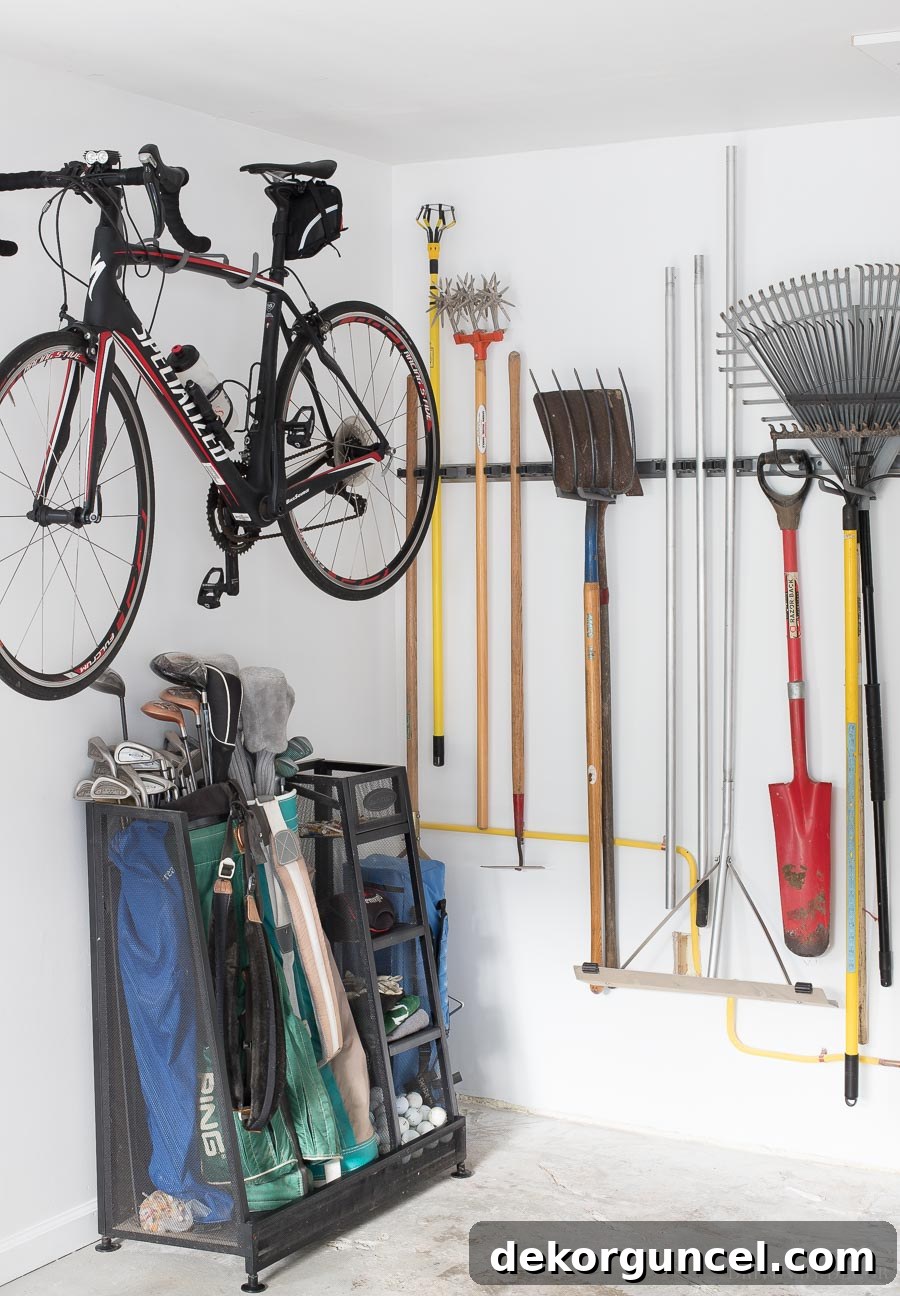 Smart ideas for storing long-handled tools, golf bags, and a bike as part of a comprehensive garage organization project!