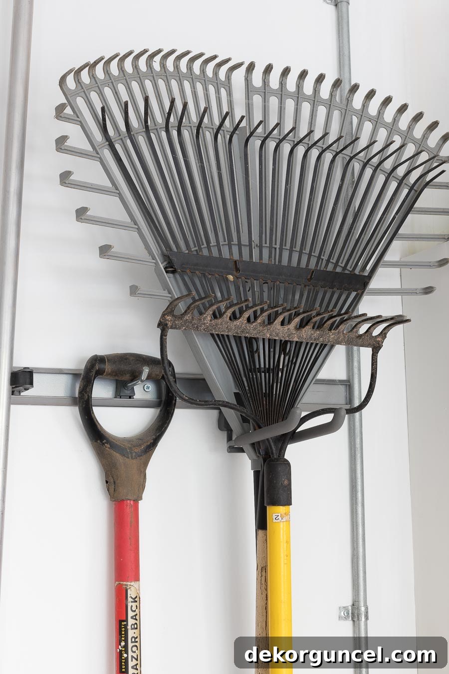 Elfa hooks specifically for hanging long-handled tools in the garage—an excellent organization system!