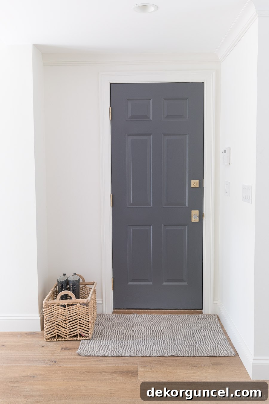 The door painted in Benjamin Moore Charcoal Slate, a stunning dark gray paint color that adds depth and sophistication to the interior design.