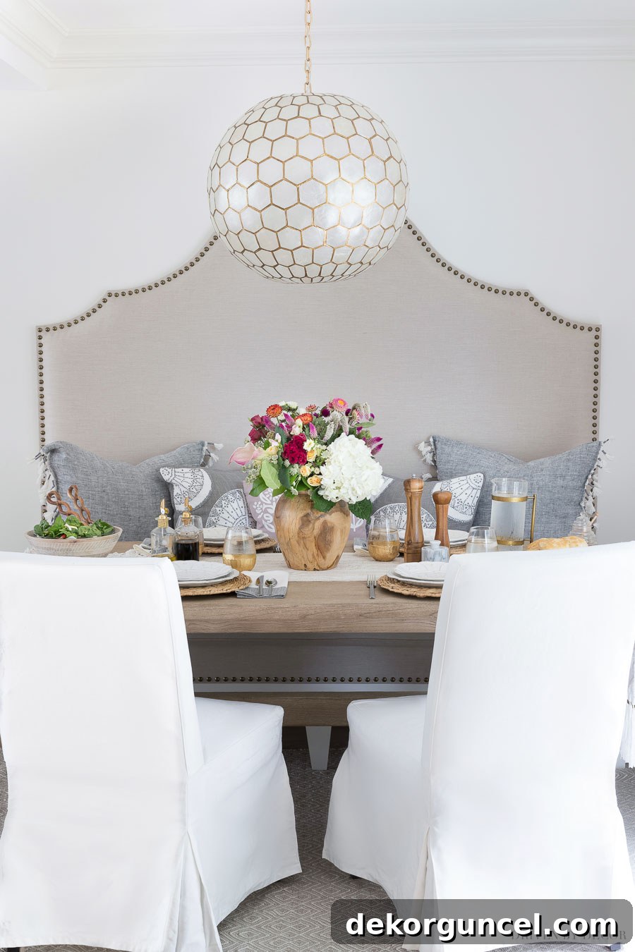 Super inexpensive white slipcovered dining chairs, perfect for adding a touch of elegance and practicality to the breakfast nook. Source information is linked in the post.
