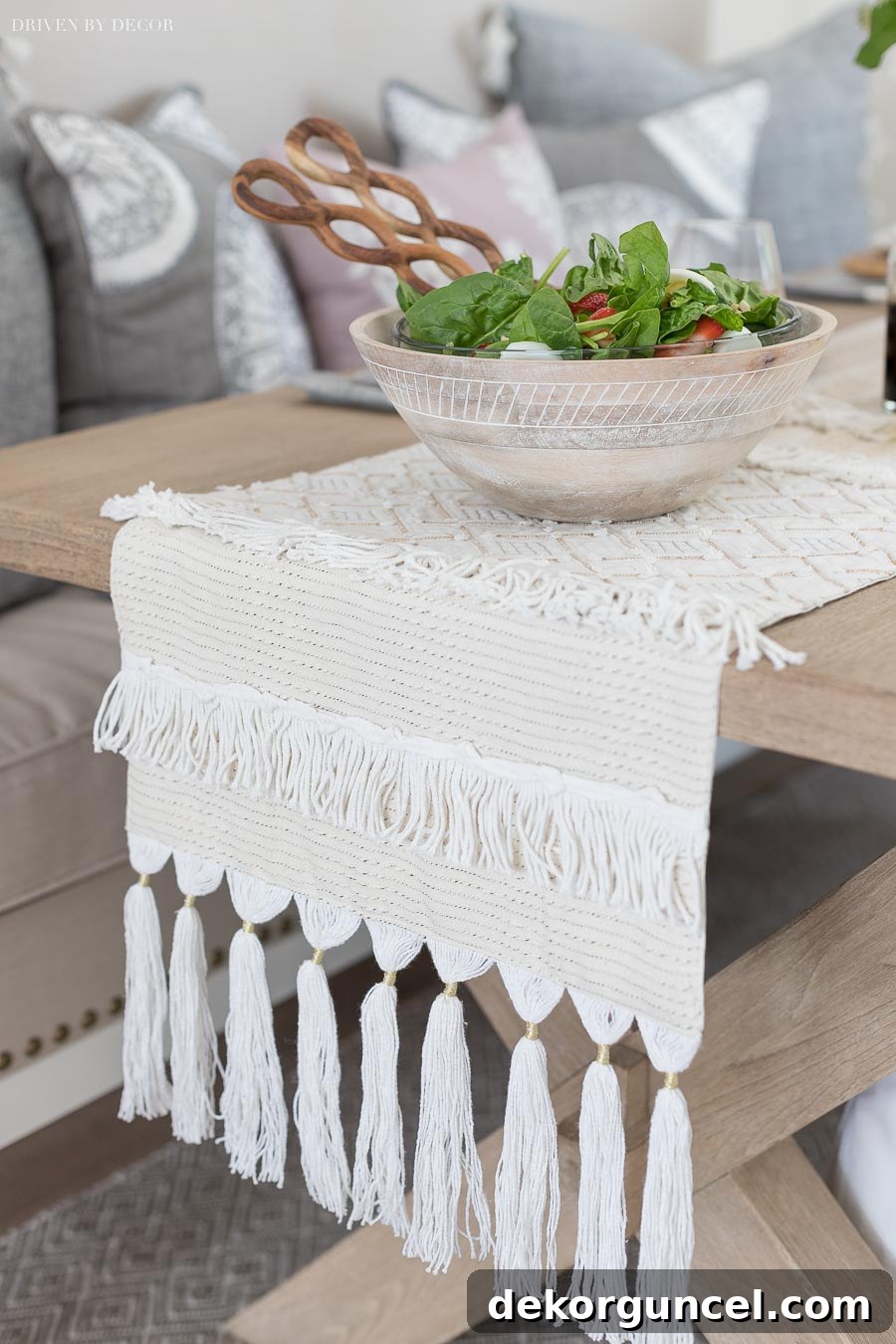 A gorgeous textured table runner with elegant fringed ends, adding a touch of rustic charm and sophistication to the dining setting.