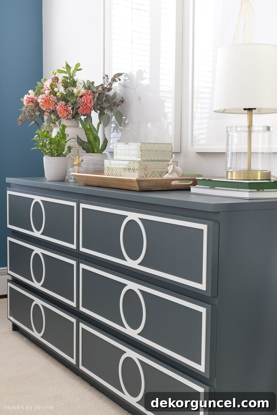 An IKEA Malm dresser dramatically transformed with a fresh paint color and decorative overlays, creating a custom and chic furniture piece.