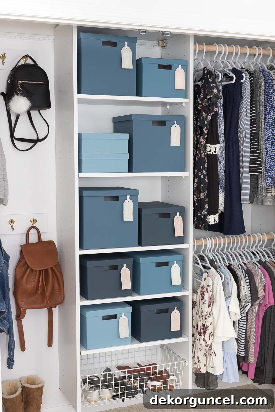 A beautifully organized closet system, freshly painted white, featuring decorative blue painted storage boxes that add a pop of color and personality.