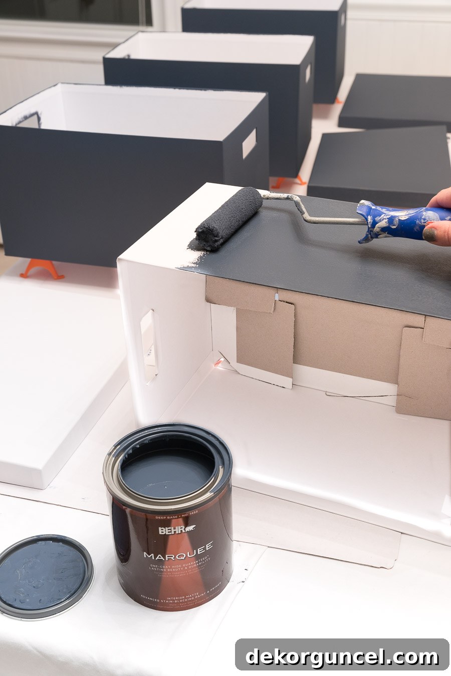 Close-up of IKEA storage boxes painted in varying shades of Behr Marquee blue paints, offering a creative and colorful organization solution for a teen's closet.