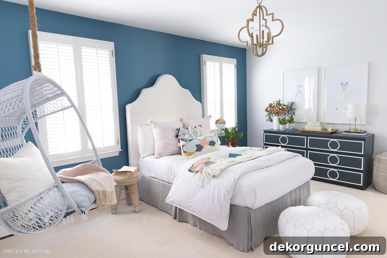 A beautifully decorated boho chic bedroom featuring an accent wall painted in Behr Marquee's Blueprint, complemented by bright bedding and stylish decor.