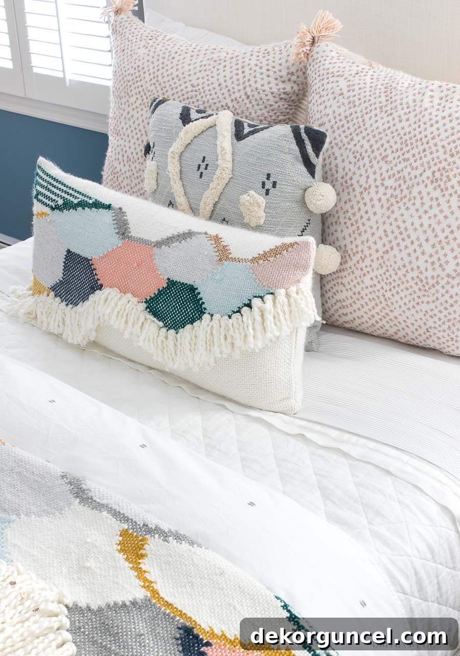 Comfortable and stylish bed in a boho chic bedroom, featuring a favorite white quilt, a neutral duvet, and a curated selection of colorful pillows.