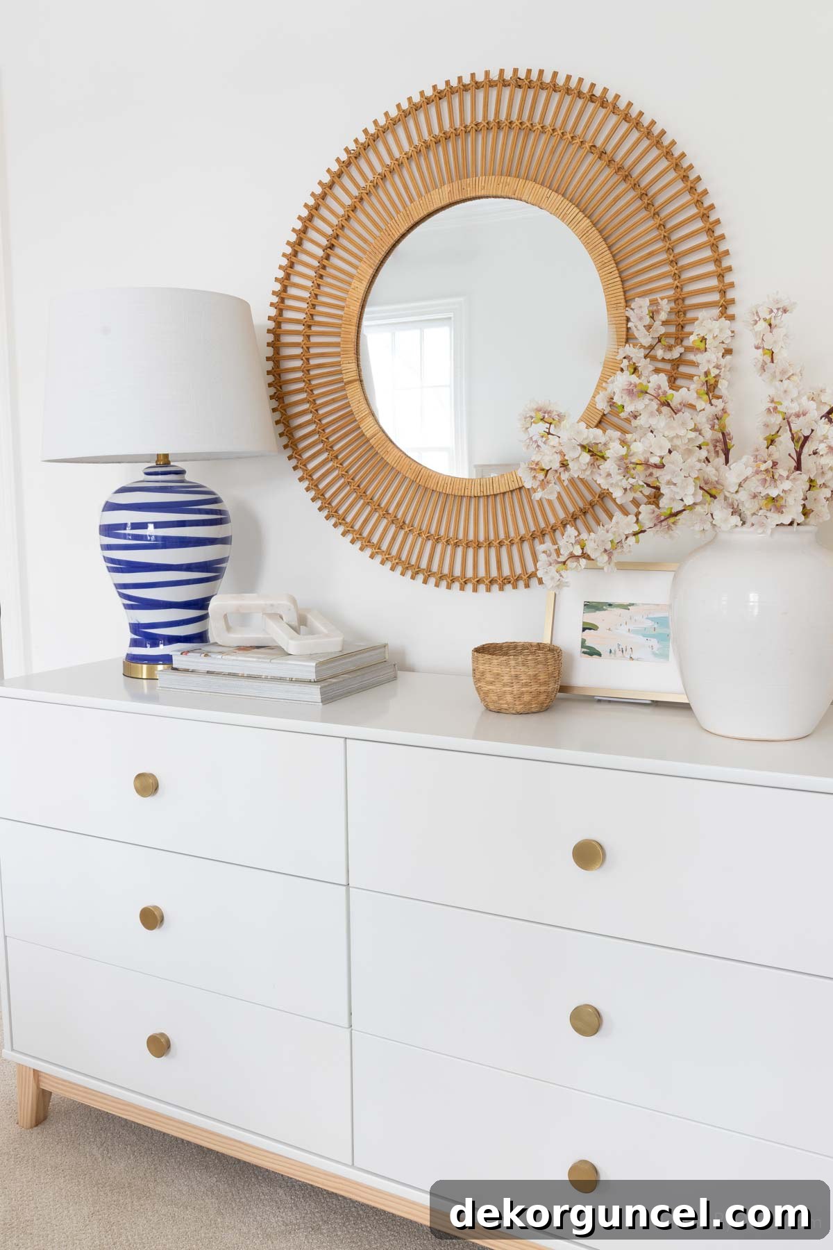 Behind the Illumination: My Home's Fixture Selections 26 A beautifully decorated bedroom dresser, featuring a blue and white brushstroke lamp as part of a thoughtful decor arrangement.