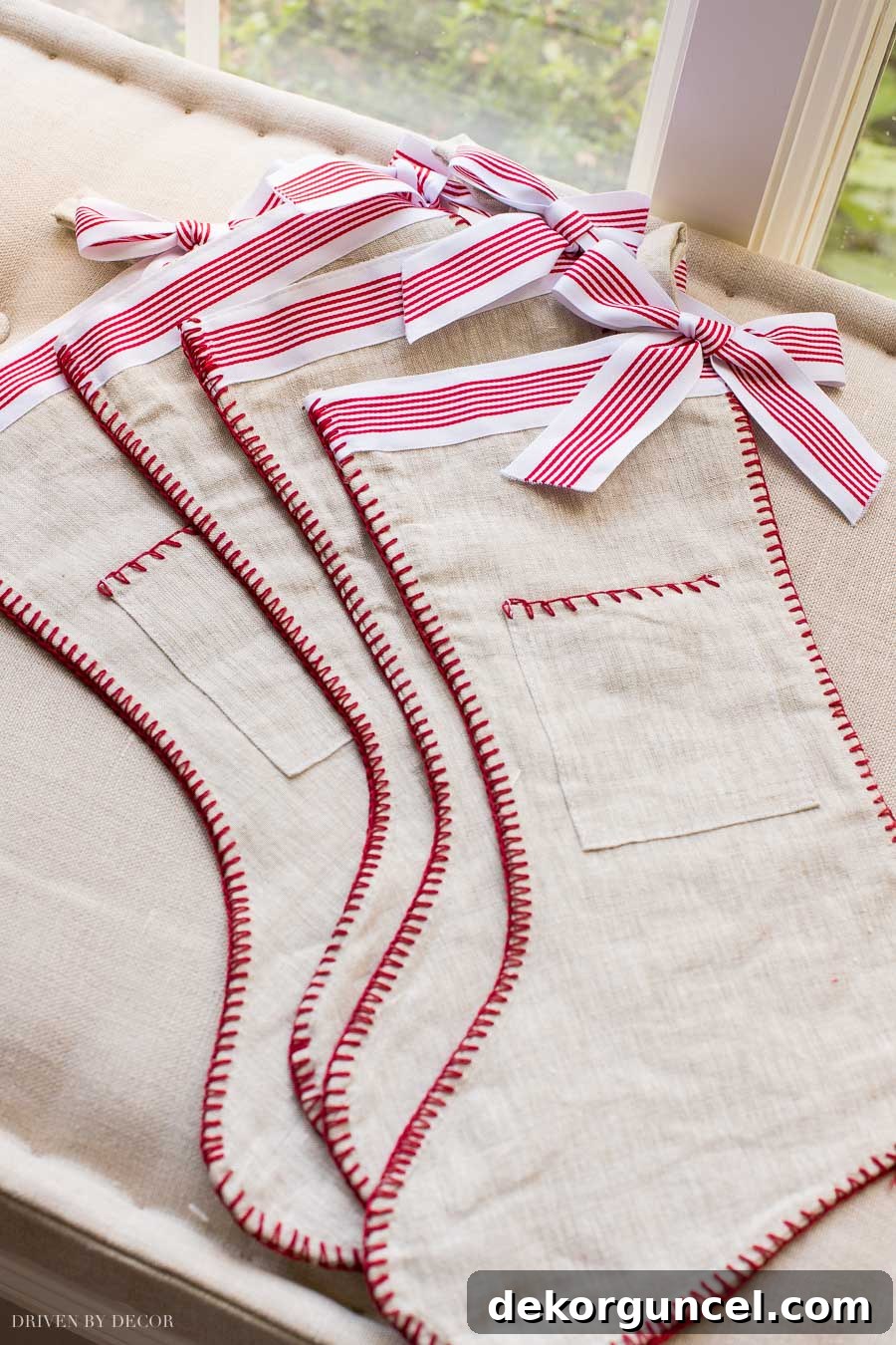 The cutest red and white ribbon stockings - love the pocket! Charming festive stockings with a classic color scheme and delightful detail.