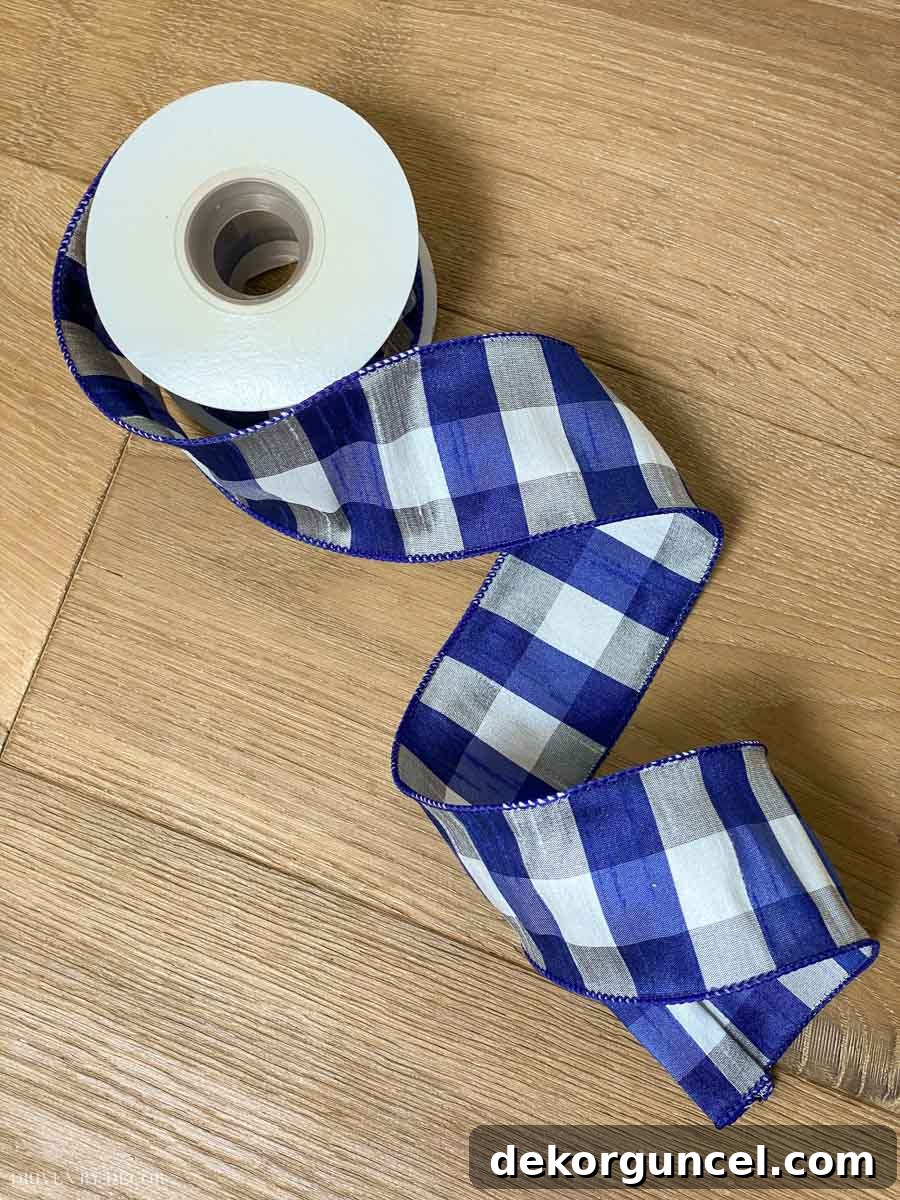 The cutest blue, white, and gray plaid wired ribbon to use on our Christmas tree! A charming ribbon with a classic plaid pattern, perfect for adding a touch of cozy elegance to holiday decorations.
