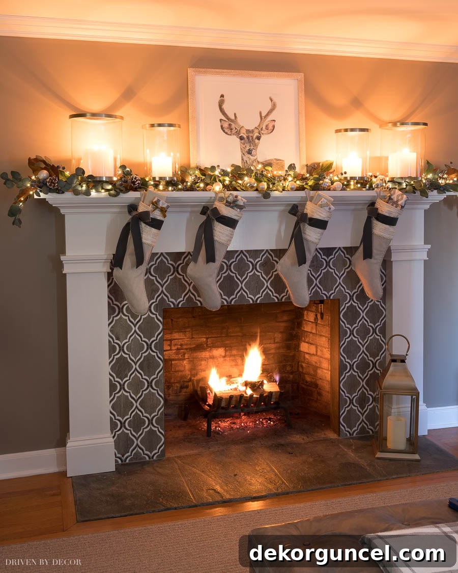 Love this Christmas fireplace mantel! Adorned with a classic garland, elegant stockings, and glowing hurricanes, creating a warm and inviting focal point in the living room.