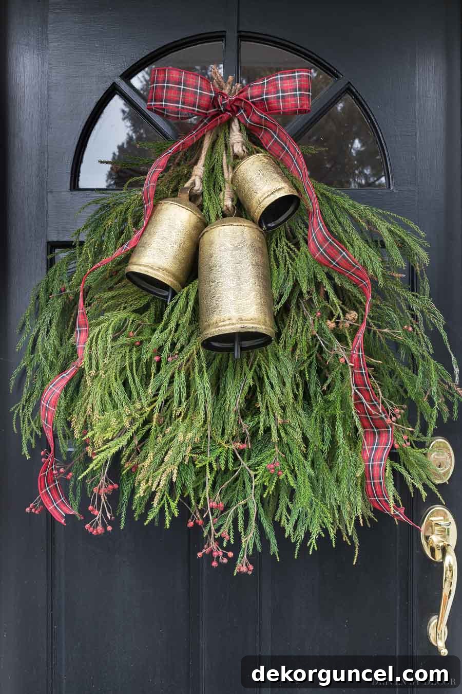 Gorgeous holiday greenery swag with a trio of brass bells and ribbon! Perfect for a festive front door.