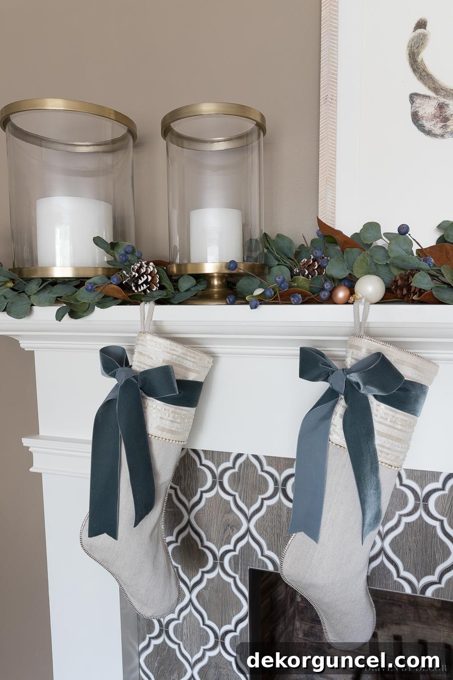 Festive fireplace mantel at Christmas, adorned with elegant brass hurricanes and a lush eucalyptus garland