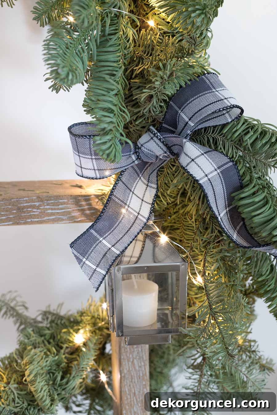 Close-up of mini lanterns integrated into a super cute Christmas card display on a festive garland