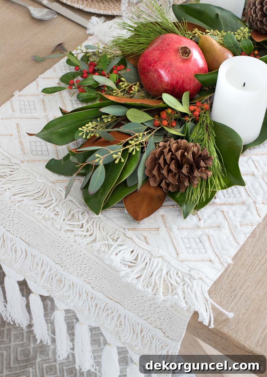 Elegant Neutral Fabric Runner: The Perfect Base for a Lush Greenery, Fruit, and Pinecone Centerpiece, Adding Contrast and Protection to Your Table.
