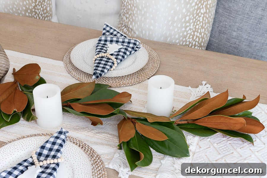 Step-by-Step Guide: Laying Magnolia Branches as the Structural Base for a Beautiful Fresh Greenery Table Runner.
