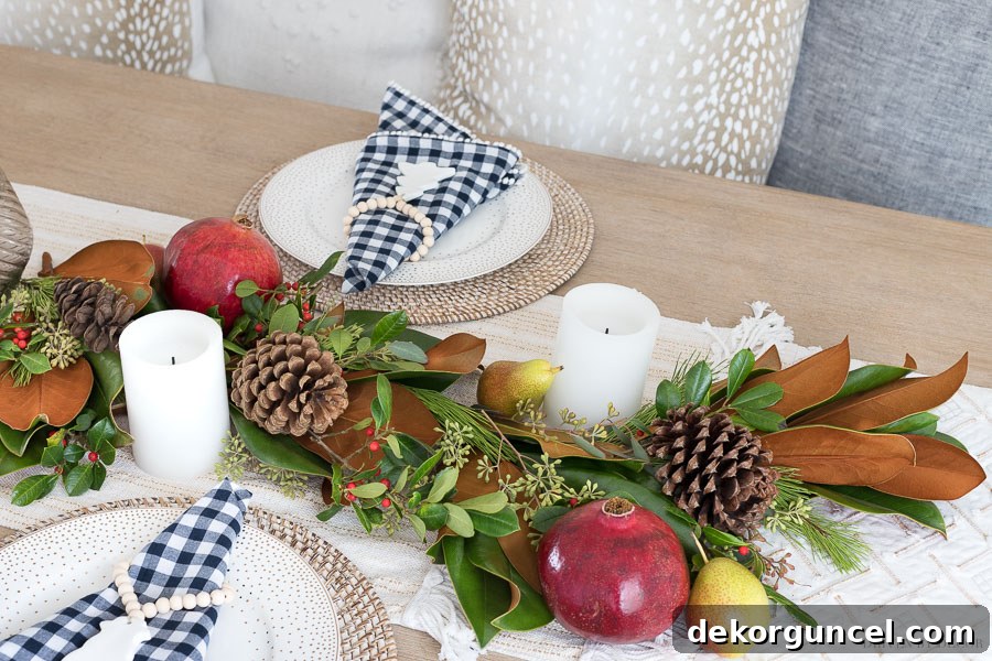 Simple Steps to Create a Fresh Greenery Table Runner: A DIY Tutorial on Layering Berries, Colorful Fruit (Pomegranates, Pears), and Pinecones for a Festive Look.