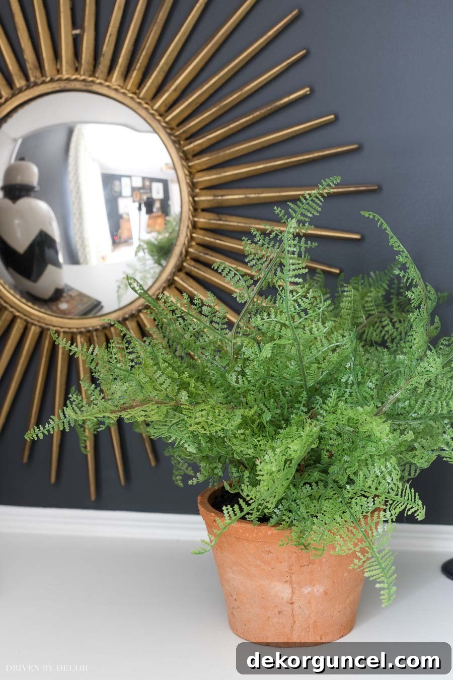 Realistic faux fern, an ideal low-maintenance plant for shaded corners of your home office.