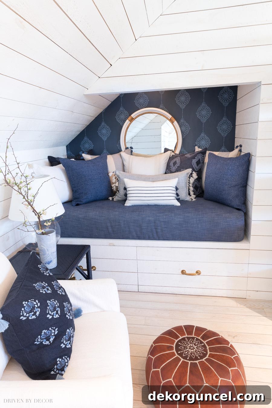 Gorgeous blue-on-blue Luna Stripe wallpaper creating a super cozy and inviting bed nook, adding playful refinement and unique charm.