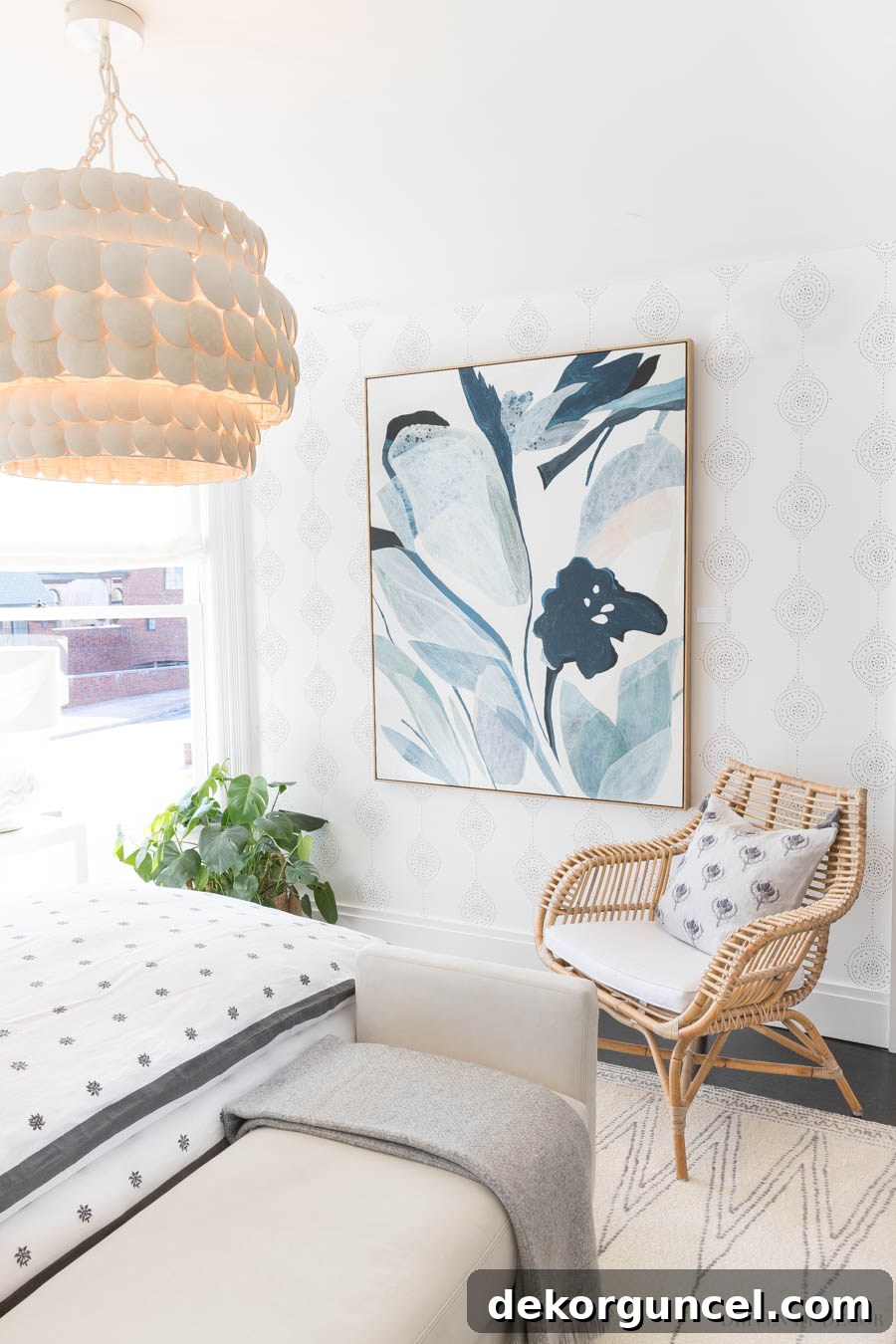 Large-scale art serves as a striking focal point in this bedroom, harmonizing with the serene Luna Stripe wallpaper and sophisticated design elements.