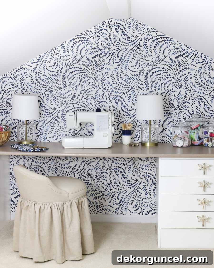 Gorgeous blue vine wallpaper transforming a craft room accent wall into an inspiring and organic space, adding artistic flair.