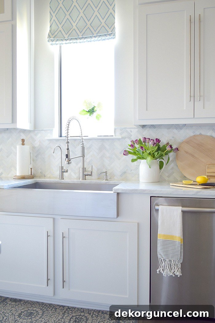 Discover the perfect height for your kitchen backsplash by ending it neatly at the base of your upper cabinets, a classic and practical choice for any kitchen style, as shown in this beautiful example.