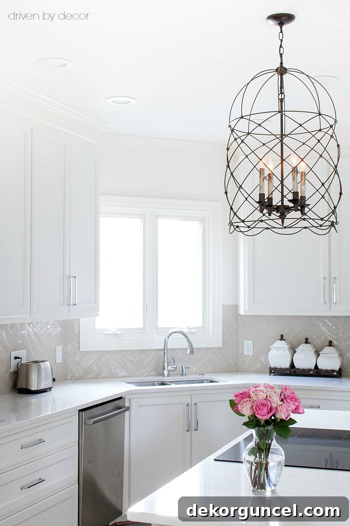 Kitchen Backsplash Height Guide 4 A practical and stylish guide to kitchen backsplash height, demonstrating how to effectively stop tile at the bottom of upper cabinets with larger scale herringbone patterns for a refined finish.