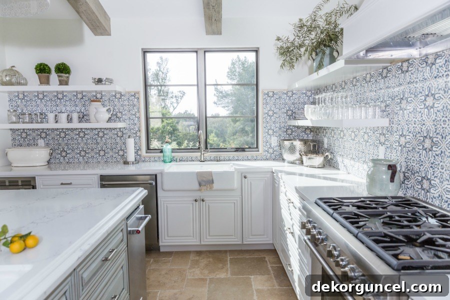 Get inspired by this beautiful kitchen with open shelving, showing how South Harlow Interiors masterfully integrated their backsplash tile, ending it perfectly at the base of the top shelf for a balanced look.