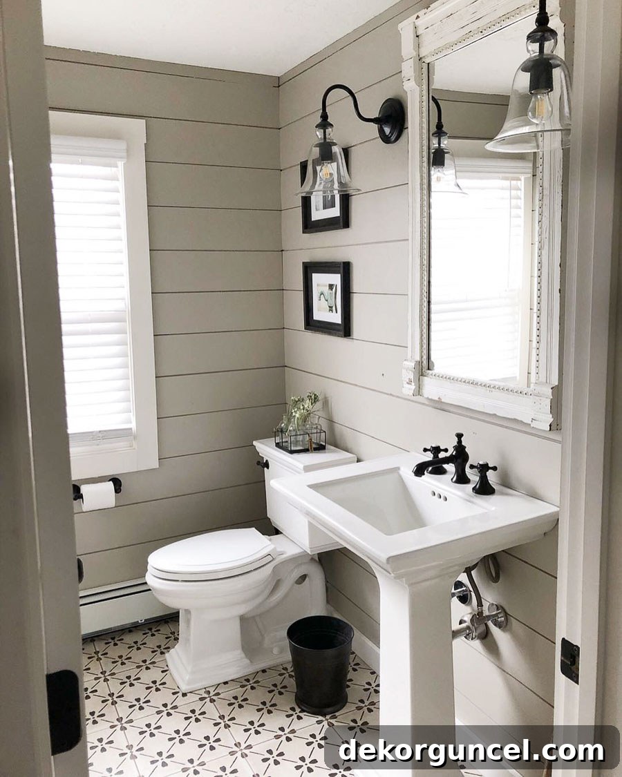 A stunning farmhouse chic bathroom showcasing Sherwin Williams Anew Gray, one of the ten best greige paint colors, by Country Dog Homes.
