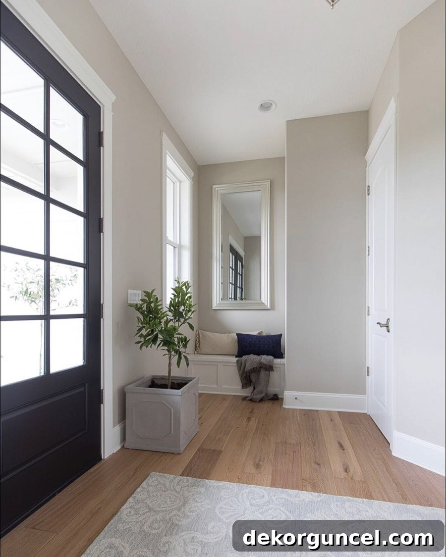 Benjamin Moore Revere Pewter in a beautifully light and airy foyer by Fridley Homes, a top reader-favorite greige.