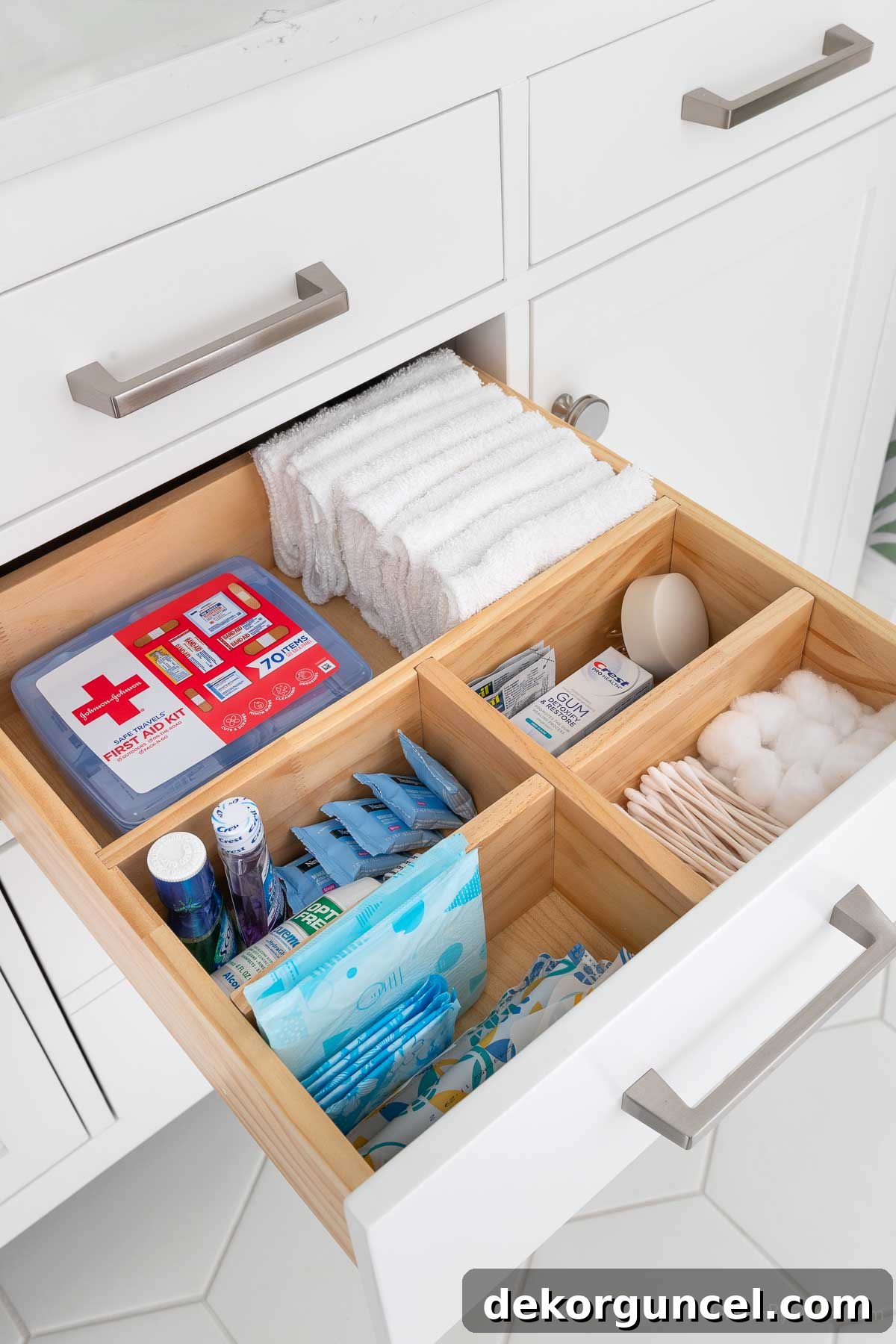 Wood dividers holding bathroom essentials in bathroom vanity drawer