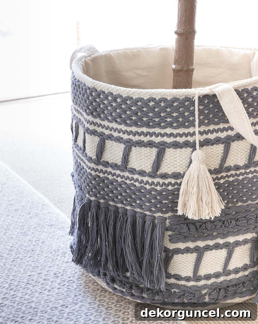 A gorgeous set of macrame tasseled baskets, with the medium size perfectly housing a faux fiddle leaf fig tree, adding texture and style.