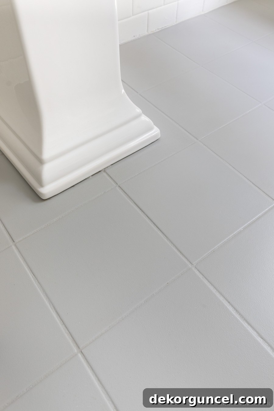 Close-up of painted tile floor in front of the sink after four years, showing minimal wear and good durability.
