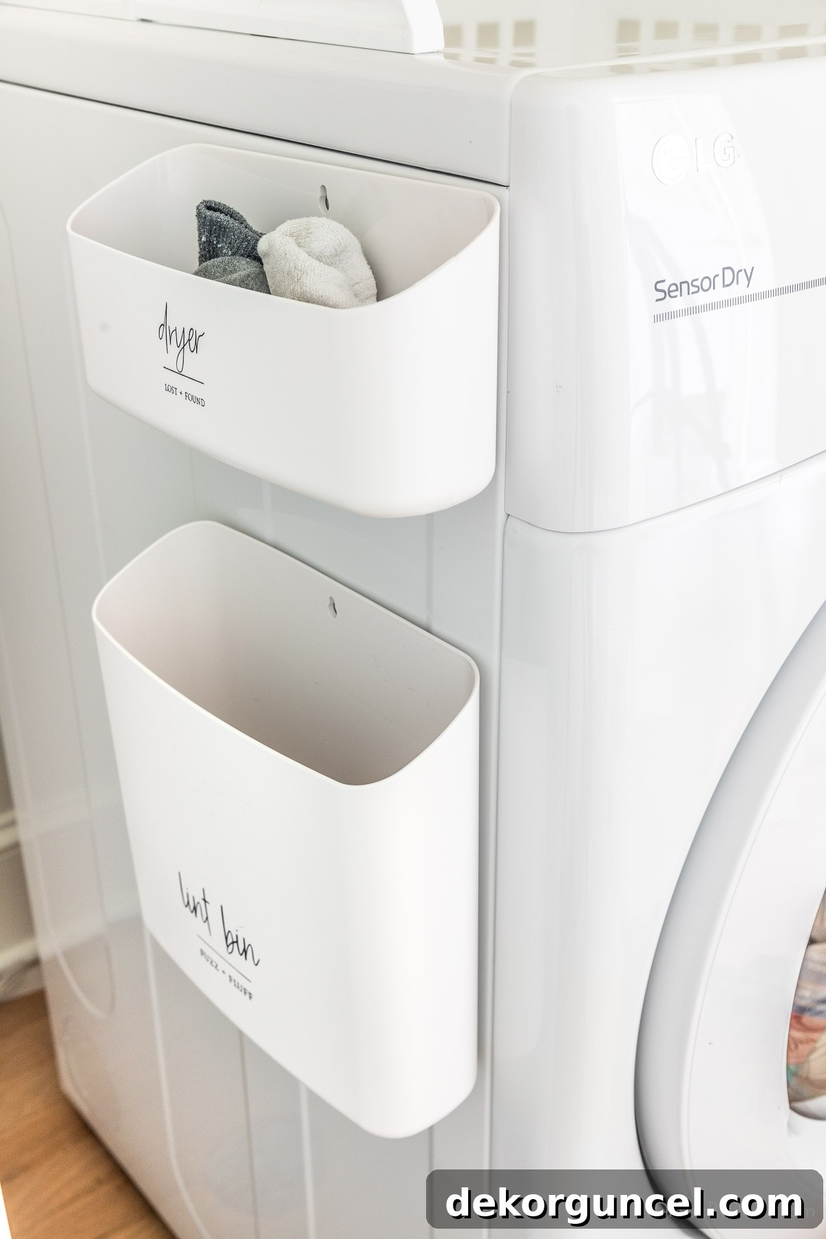 Laundry Room Storage Ideas to Maximize Your Space 6 Magnetic bins attached to the side of a dryer, used for storing lint and unpaired socks, demonstrating smart laundry room organization.