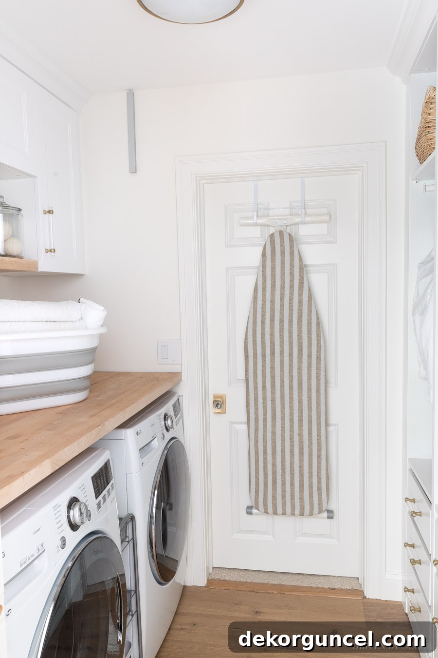 Laundry Room Storage Ideas to Maximize Your Space 7 An ironing board hanging neatly on the back of a door, illustrating an excellent space-saving technique for a laundry room.