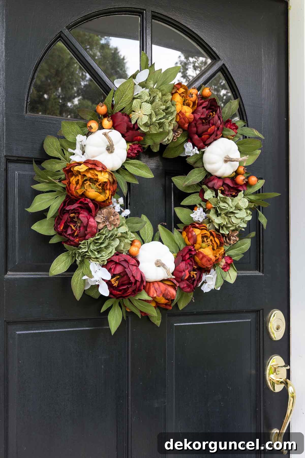 Elegant fall wreath adorned with hydrangeas, white pumpkins, berries, and pinecones, perfect for a sophisticated autumn front door.