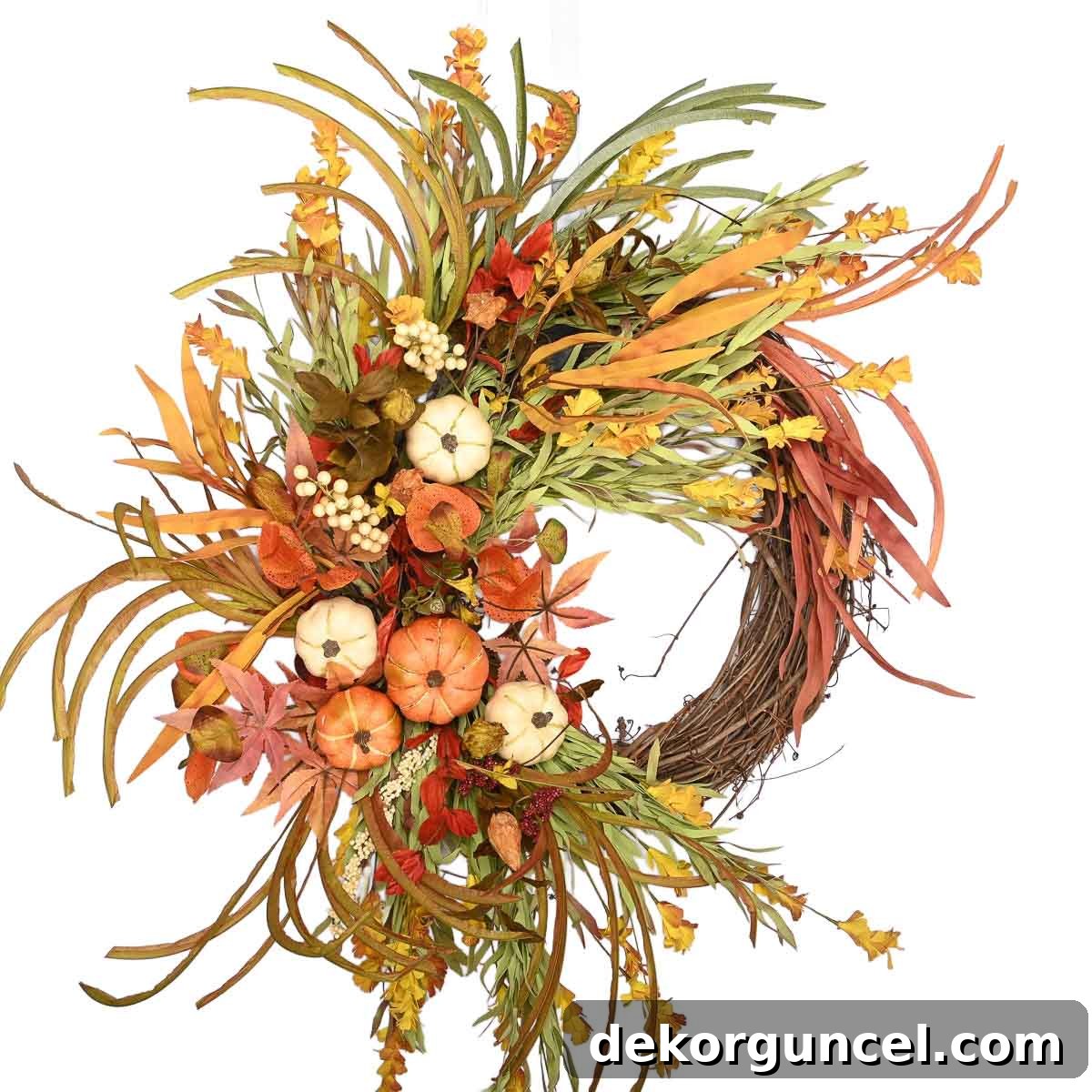 A budget-friendly fall grapevine wreath elegantly decorated with autumnal grasses and charming small pumpkins for a rustic look.