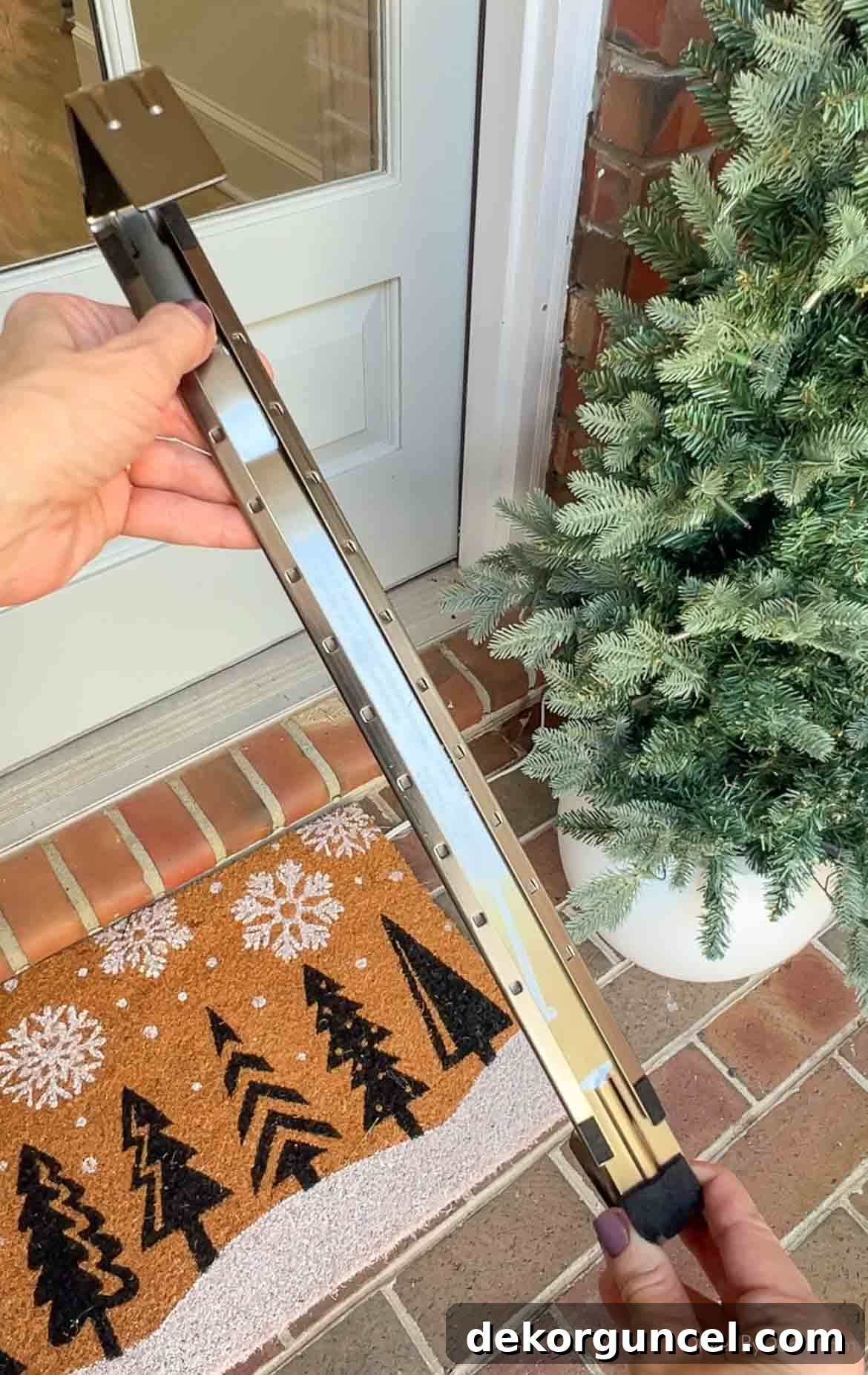 An innovative adjustable wreath hanger with felt padding, designed to protect your door while allowing precise height adjustments for your wreath.