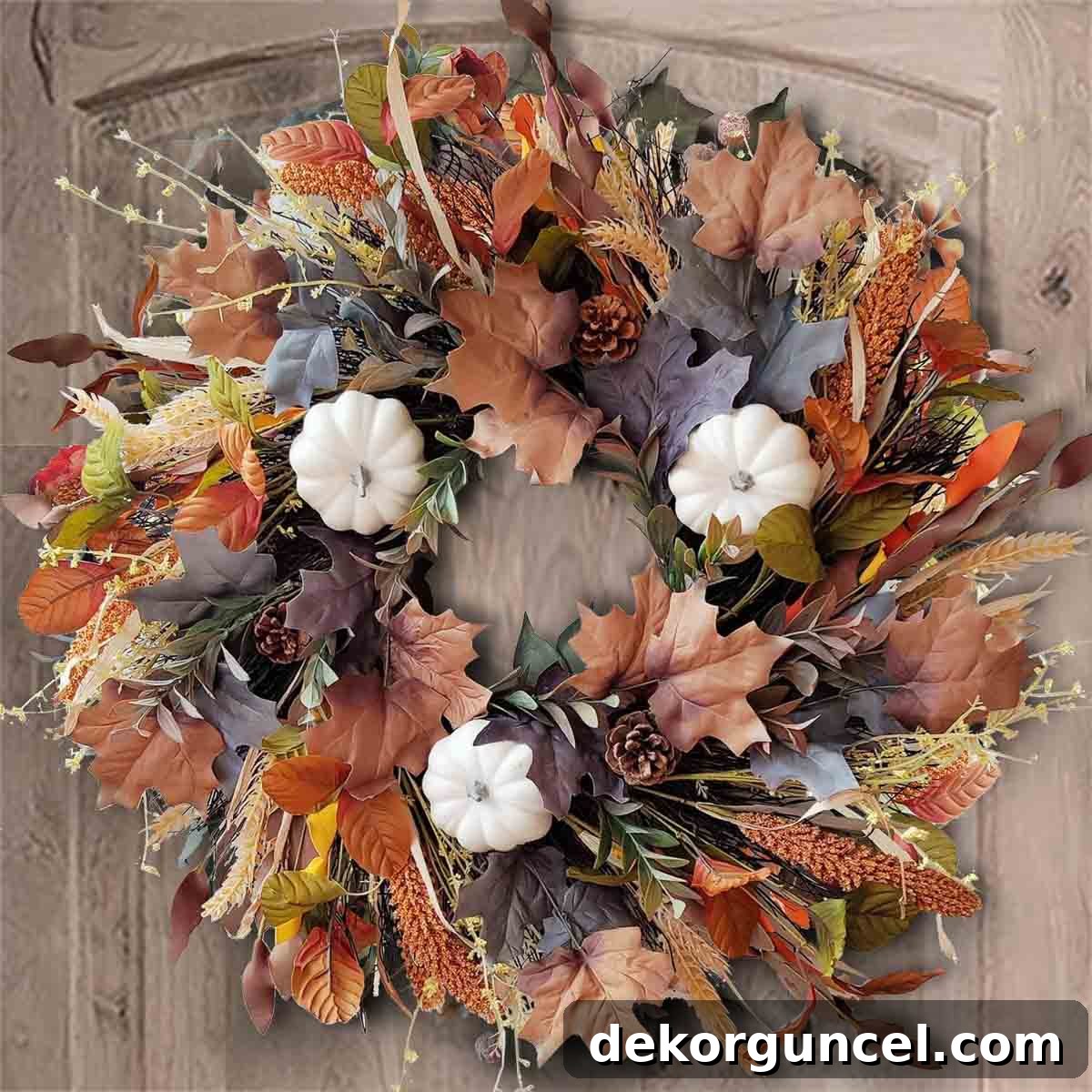 Budget-friendly fall wreath artfully arranged with a charming mix of autumn leaves, small pumpkins, and delicate ornamental grasses.