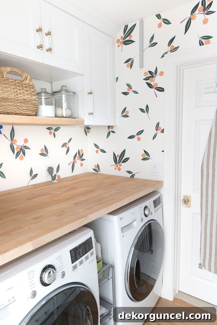 Vibrant tangerine vinyl wall decals bring a cheerful and refreshing look to a modern laundry room.