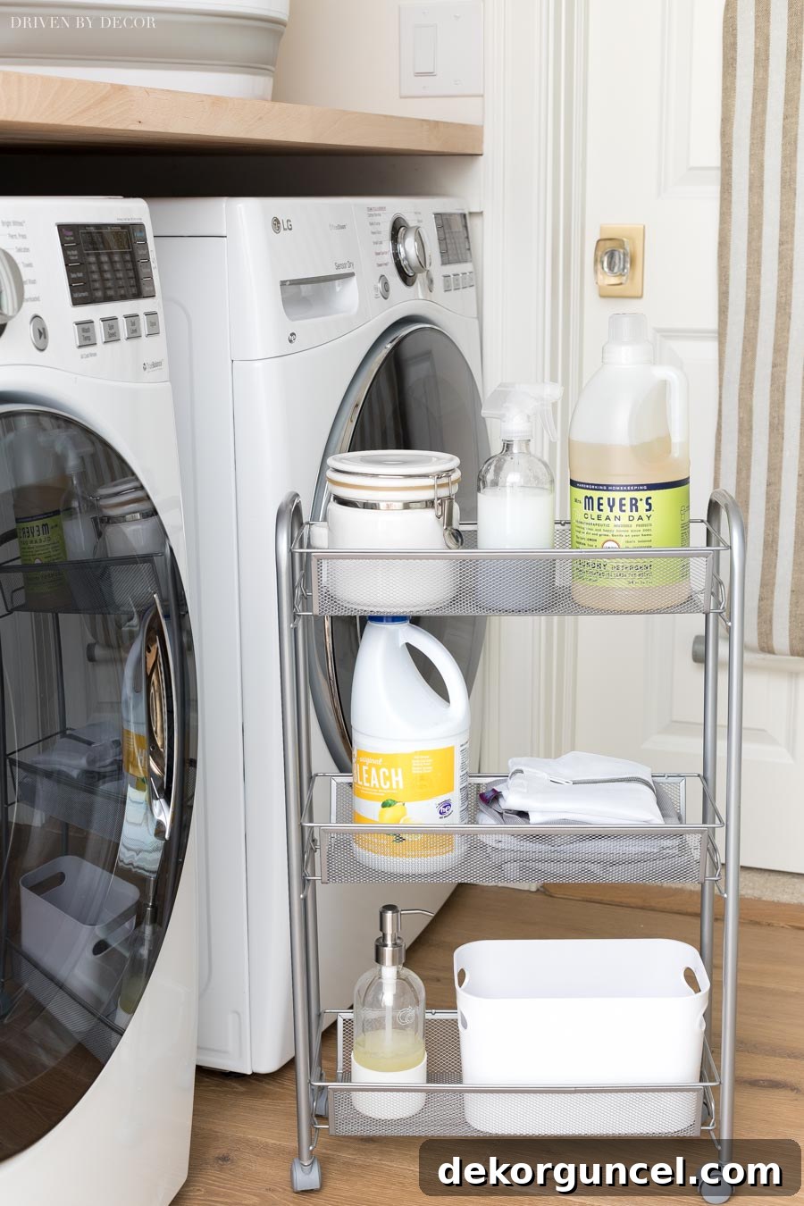 A slim, rolling storage cart positioned between a washer and dryer, demonstrating smart and efficient laundry room storage solutions.