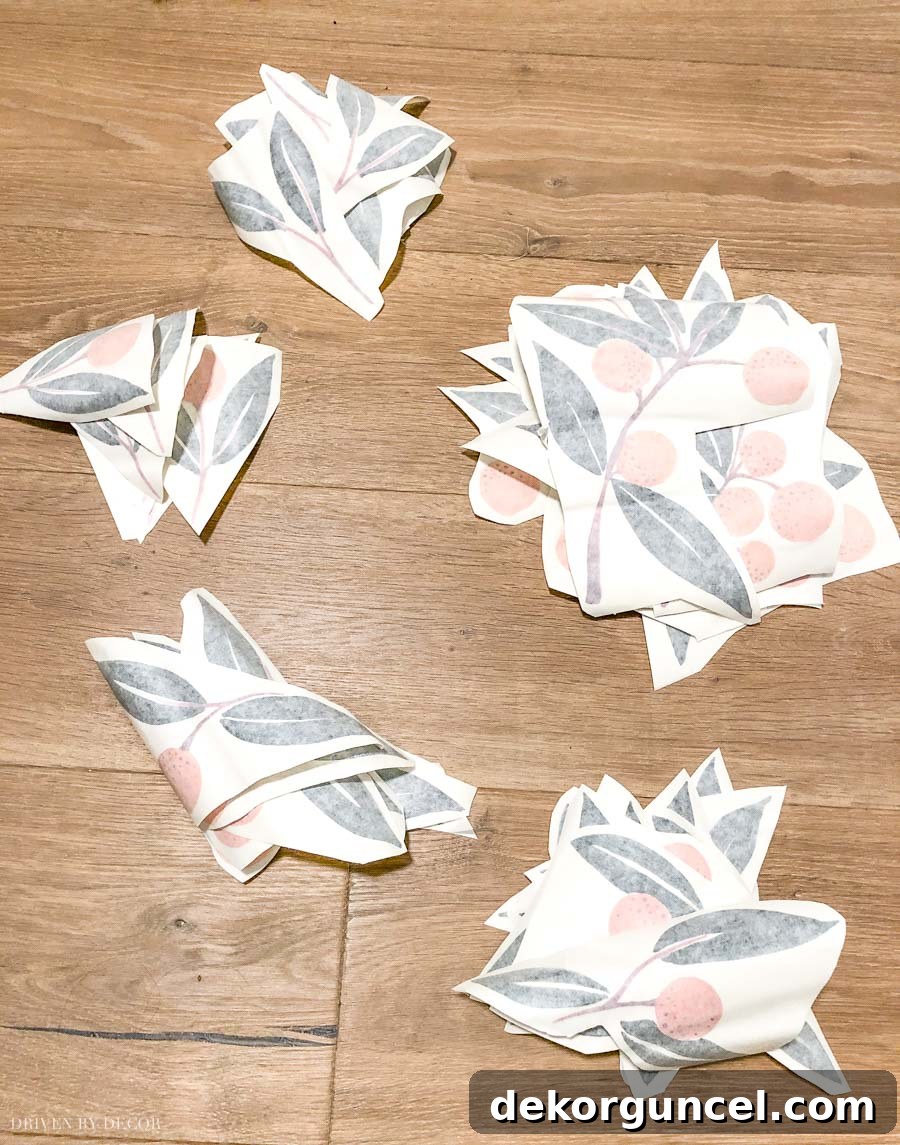 Assortment of vinyl wall decals cut from their original roll and neatly organized into piles by size and design, ready for layout planning.