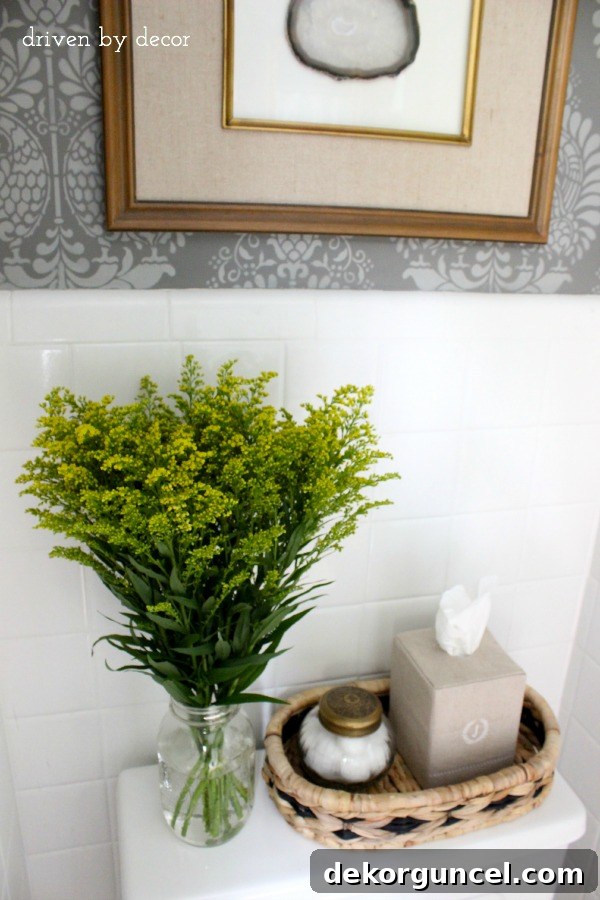 Affordable Bathroom Renovation Ideas 15 Decor accessories elegantly arranged on top of the toilet tank