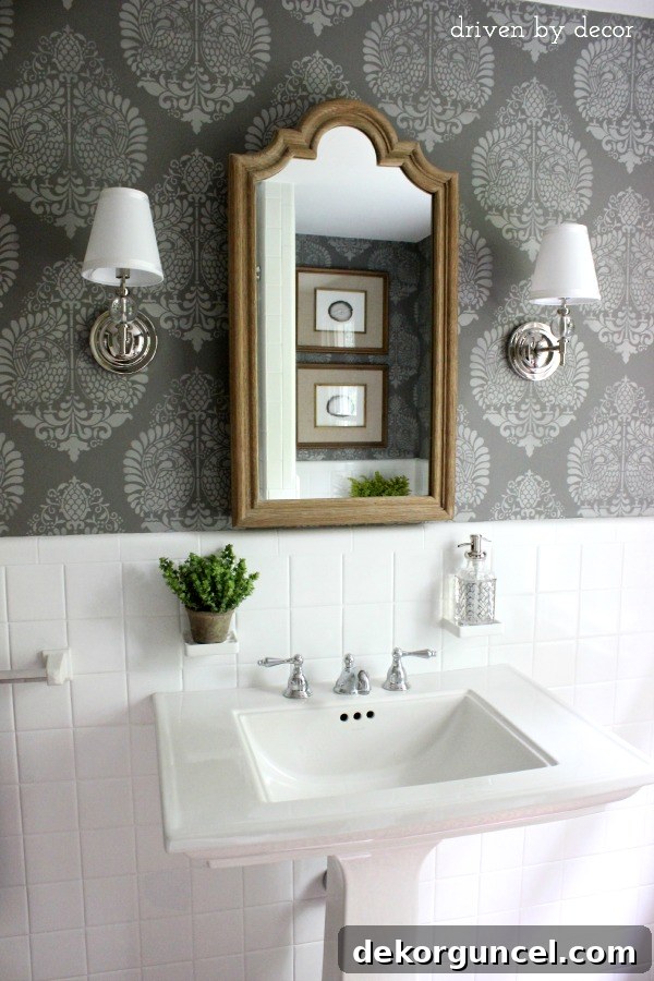 Affordable Bathroom Renovation Ideas 3 Newly remodeled hall bathroom with stenciled walls in Benjamin Moore Chelsea Gray, wood medicine cabinet, and sconces