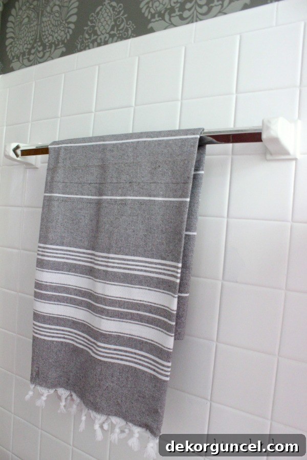 Affordable Bathroom Renovation Ideas 9 New chrome towel bar with a stylish gray and white striped Turkish towel
