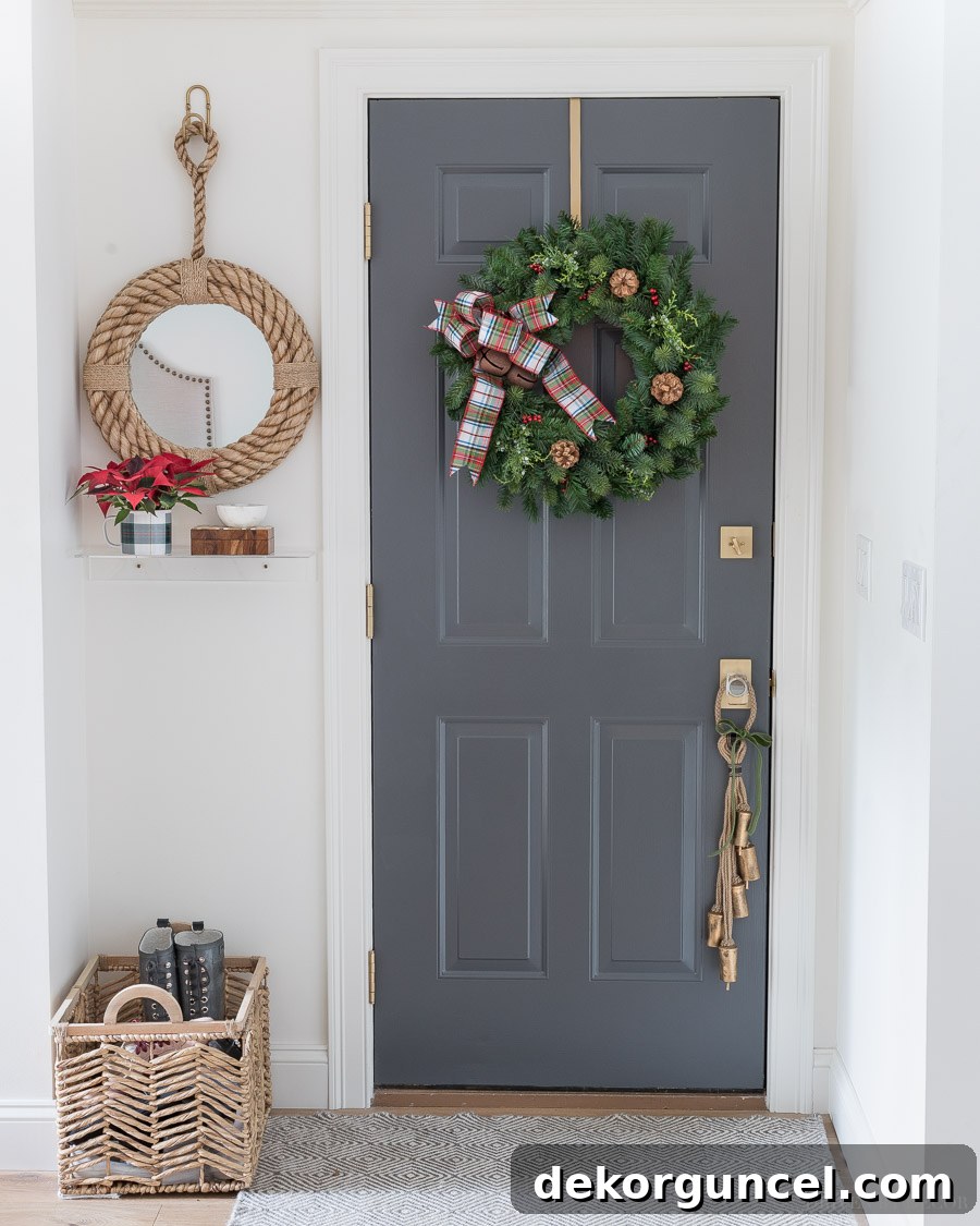 Our garage access door, beautifully decorated for Christmas with a festive wreath, plaid bow, jingle bells, and a unique rope door hanger.