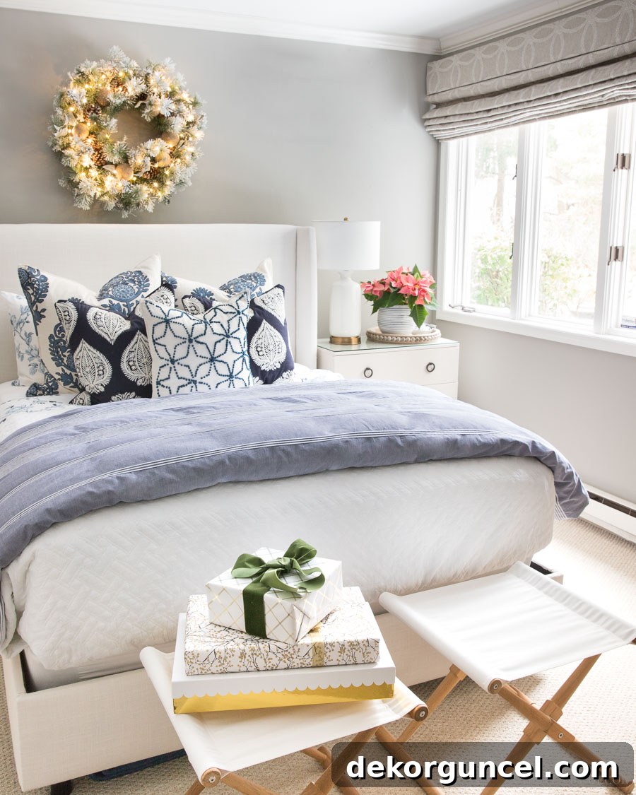 Our beautifully appointed guest room featuring elegant blue and white bedding, stunning decorative pillows, and subtle Christmas touches.
