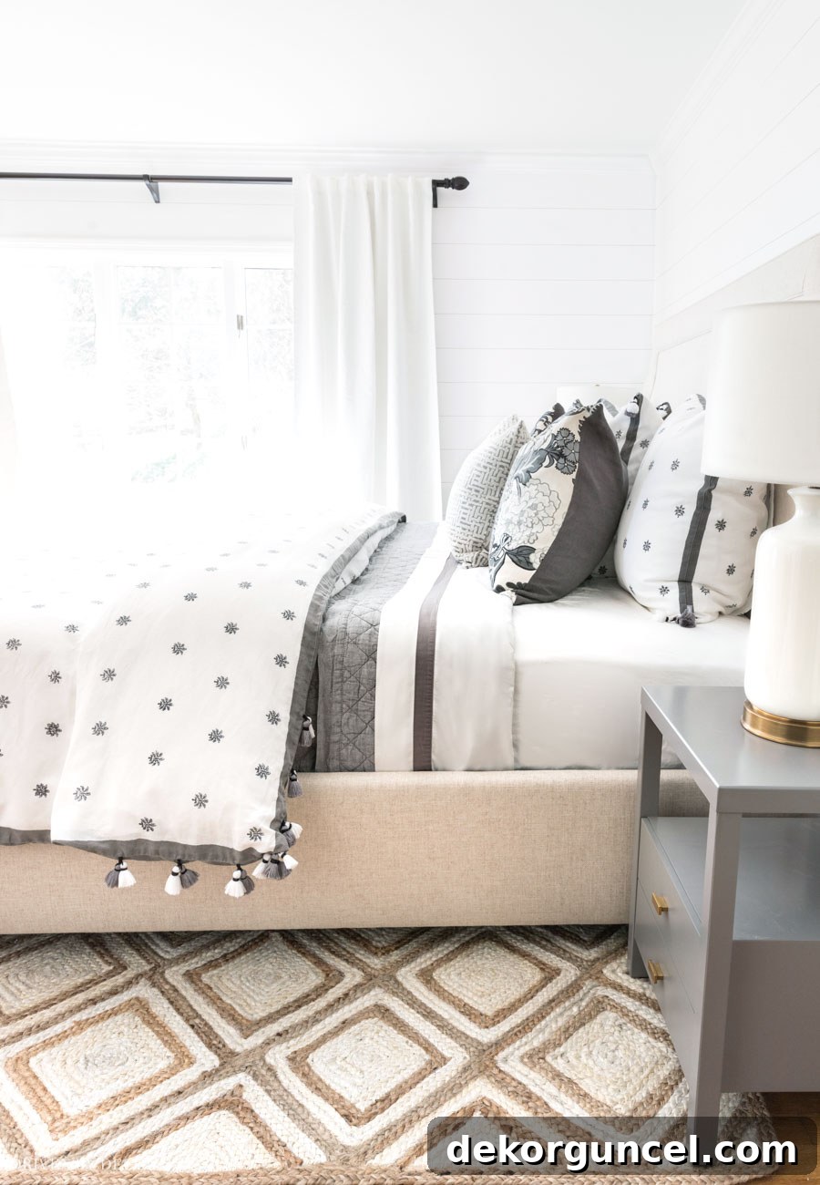 Showcasing the perfect medium thickness of the patterned jute rug in a bedroom setting.
