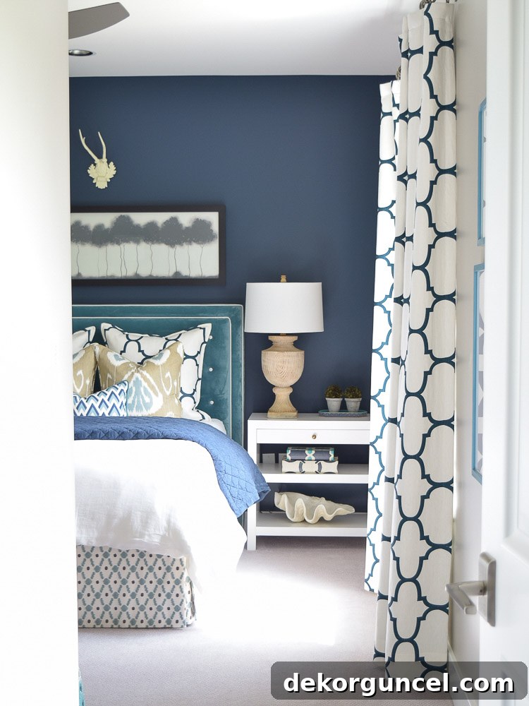 An elegant guest room featuring Benjamin Moore Gentleman's Gray on the walls, a popular dark blue paint color.